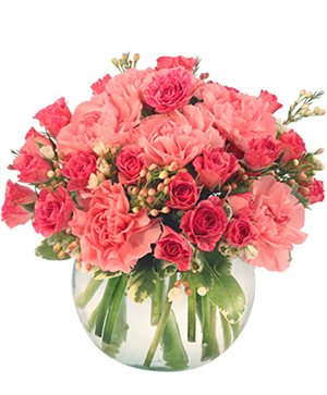 A bowl of coral roses and carnations